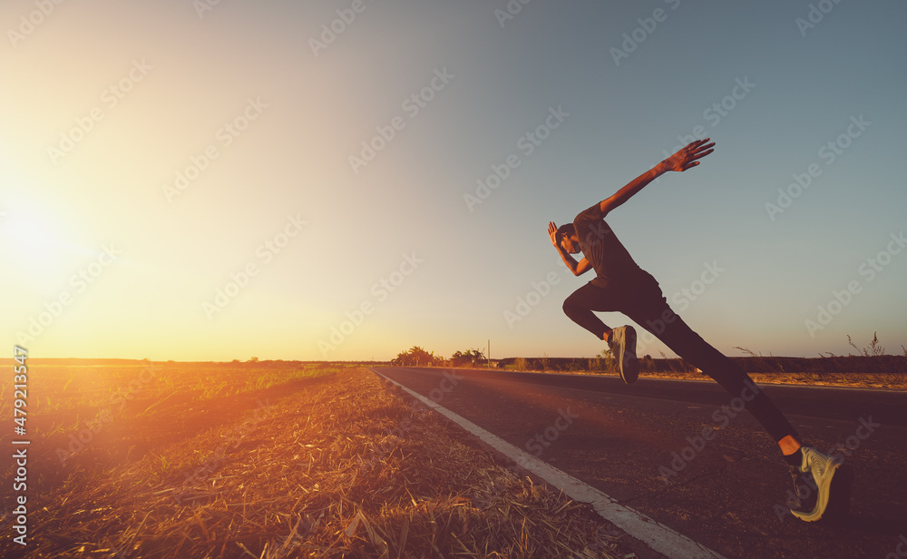 Fototapeta premium Athlete runner feet running on road, Jogging at outdoors. Man running for exercise.Sports and healthy lifestyle concept.
