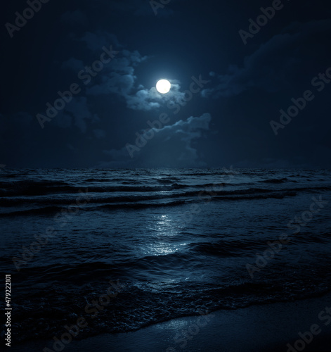 Fototapeta Naklejka Na Ścianę i Meble -  Moon over blue sea or ocean. Night view. A good background for the theme of travel, vacation, voyage.