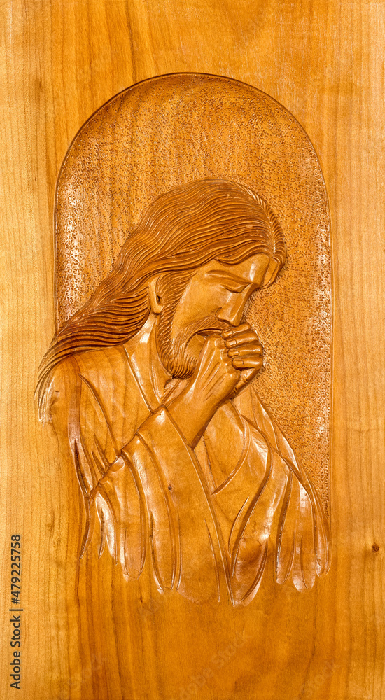 Wood carving basrelief of Jesus Christ praying. Stock Photo Adobe Stock