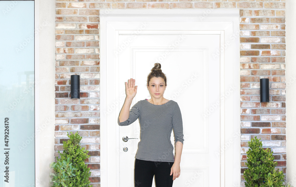 Beautiful woman opening the door of her home. Beautiful woman opening the door of her home.