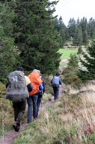 Hikers with huge backpacks on a foggy day in Vosges, France