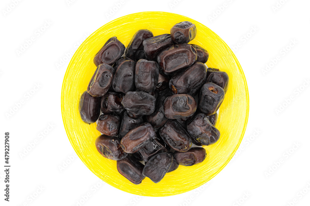 Delicious dried dates on a yellow plate isolated on a white background Delicious dried dates on a yellow plate isolated on a white background