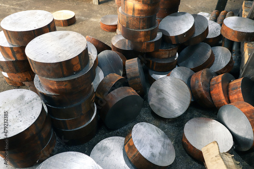 Round steel rods sawn into identical blanks for further processing on machine tools. Close-up with selective focus.  photo