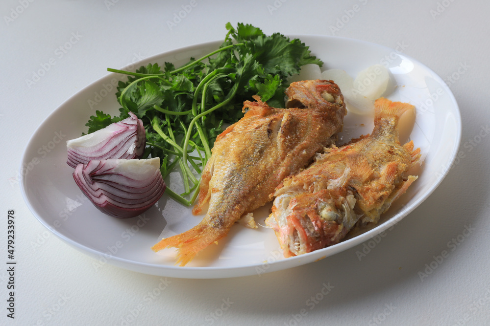 White background. Fried coral fish on plate