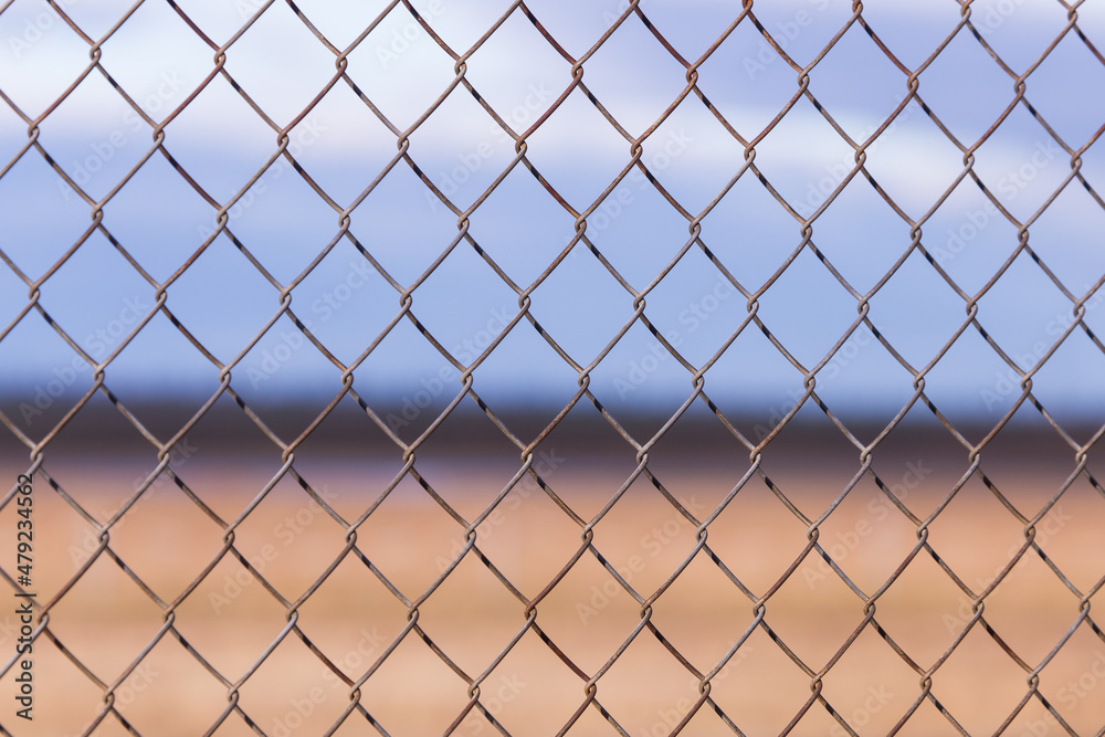 Chicken wire pattern closeup with brown background Chicken wire pattern closeup with brown background