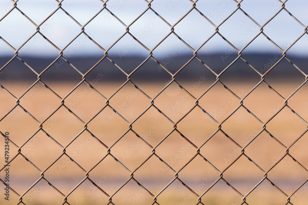 Chicken wire pattern closeup with brown background Chicken wire pattern closeup with brown background