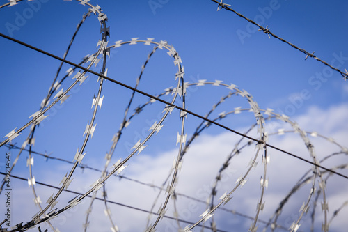 NATO barb wire with sharp and dangerous razor blades at a state border in europe 