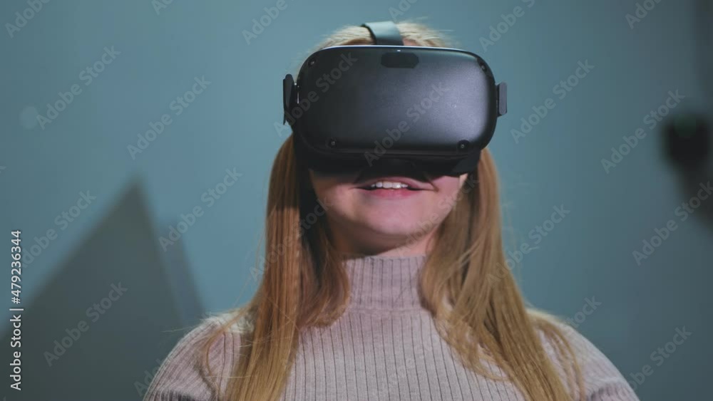 The girl plays virtual reality games in the club. The girl plays virtual reality games in the club.