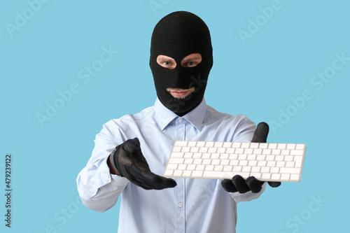 Hacker with keyboard on col...