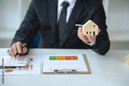 The real estate broker is explaining about the homes on the project and the income and profits to be invested after the housing project is sold.