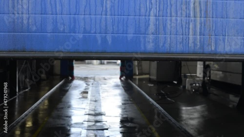 Dirty truck wash blue gate rolls up in winter time. Olomouc CSAD, Czech Rep