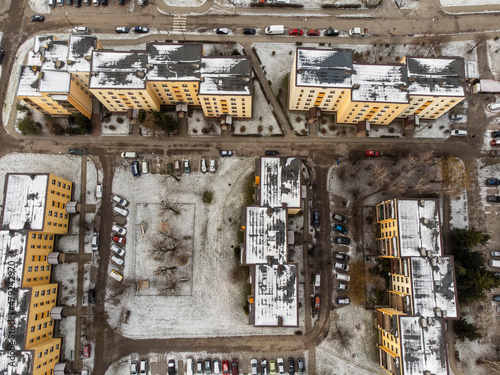 Multi-family houses seen from bird height on a cloudy winter day.