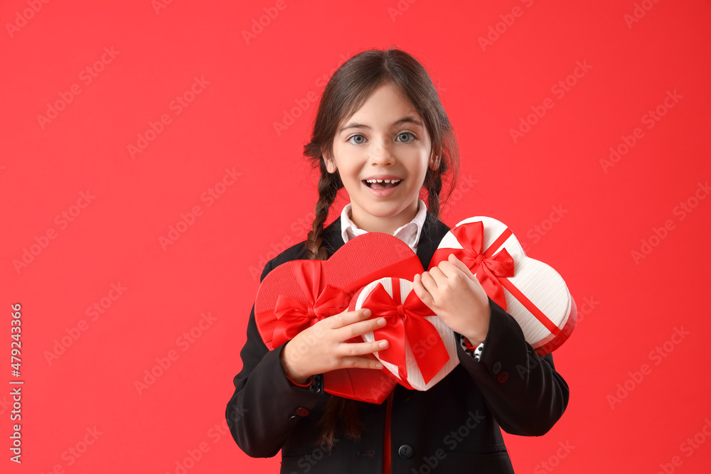 Funny little girl with gifts on color background. Valentine's Day celebration Funny little girl with gifts on color background. Valentine's Day celebration
