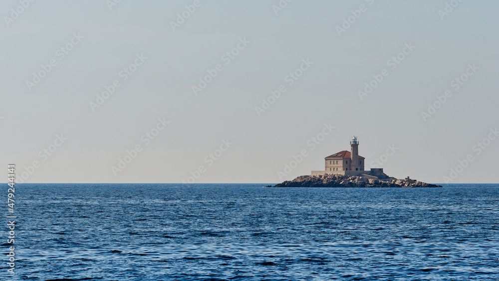Lighthouse in the Adriatic Sea near the coast of Croatia. An old building that served as navigation for passing ships. Copy space