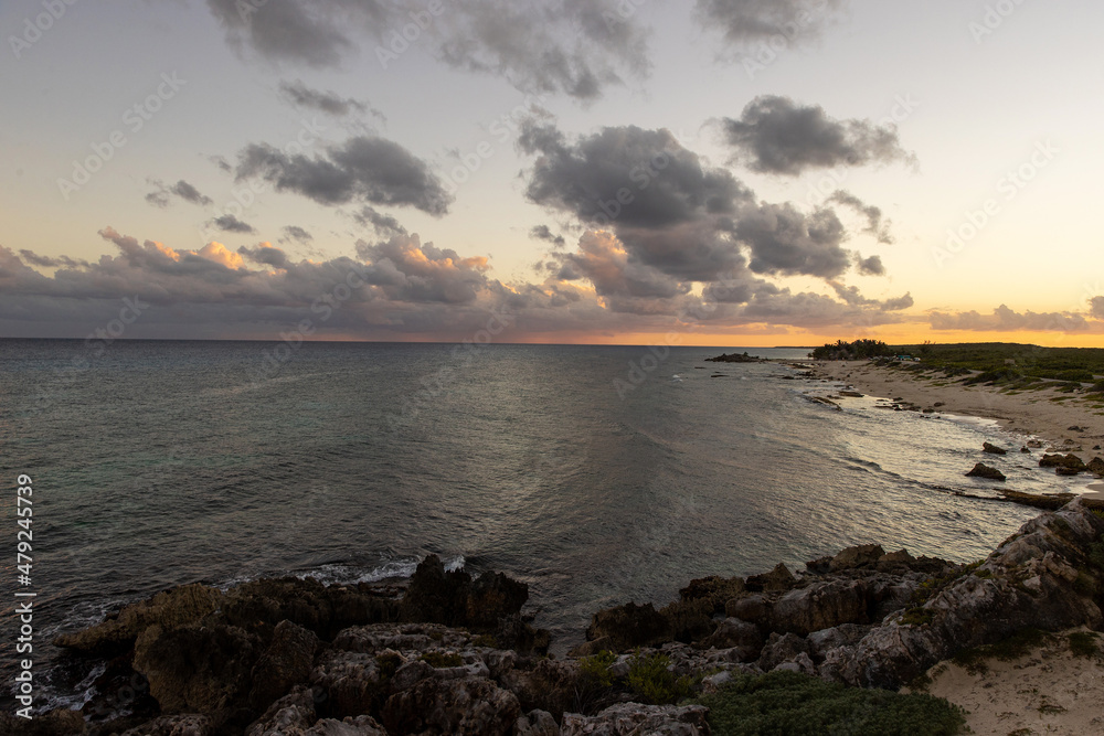 Beautiful view of sunset over the Caribbean sea seen from the shore of tropical island Cozumel, Mexico in Quintana Roo. Beautiful view of sunset over the Caribbean sea seen from the shore of tropical island Cozumel, Mexico in Quintana Roo.