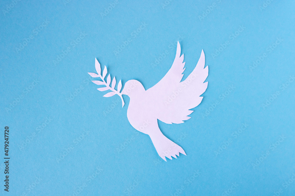 A white dove cut out of paper for the background of the World Peace Day. World Science Day for Peace and Development - obrazy, fototapety, plakaty 