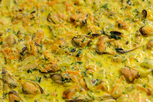 Stewed Mediterranean seafood in creme, mussels background