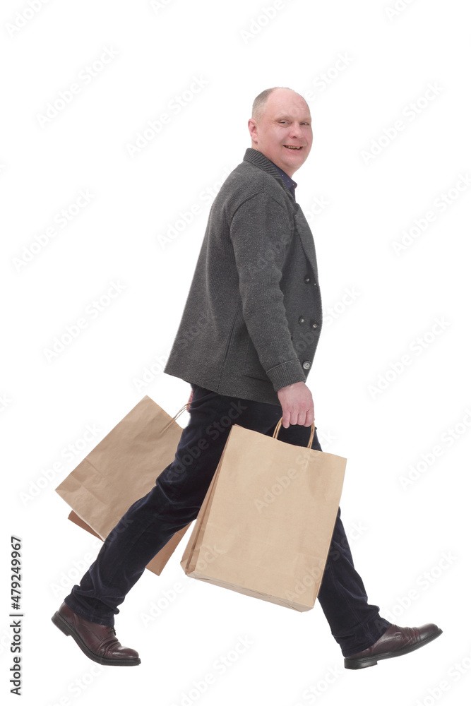 cheerful casual man with shopping bags .isolated on a white background. cheerful casual man with shopping bags .isolated on a white background.