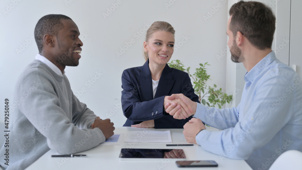 Mixed Race Business People Shaking Hands after Discussion Mixed Race Business People Shaking Hands after Discussion