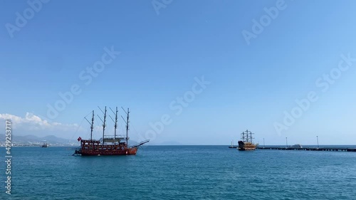 An old pirate ship at sea on a clear sunny day photo