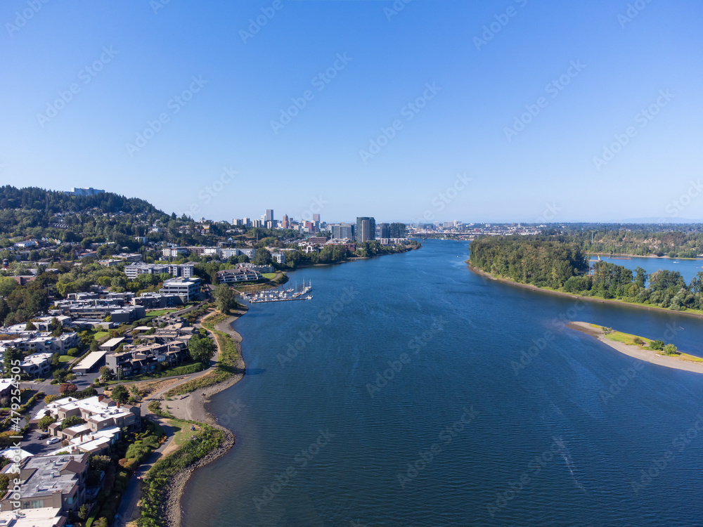 Beautiful panorama. City on the river bank. Lots of greenery. Mountains can be seen in the distance. Boating, fishing, trade, tourism, recreation, excursions. Advertising of tourist destinations.