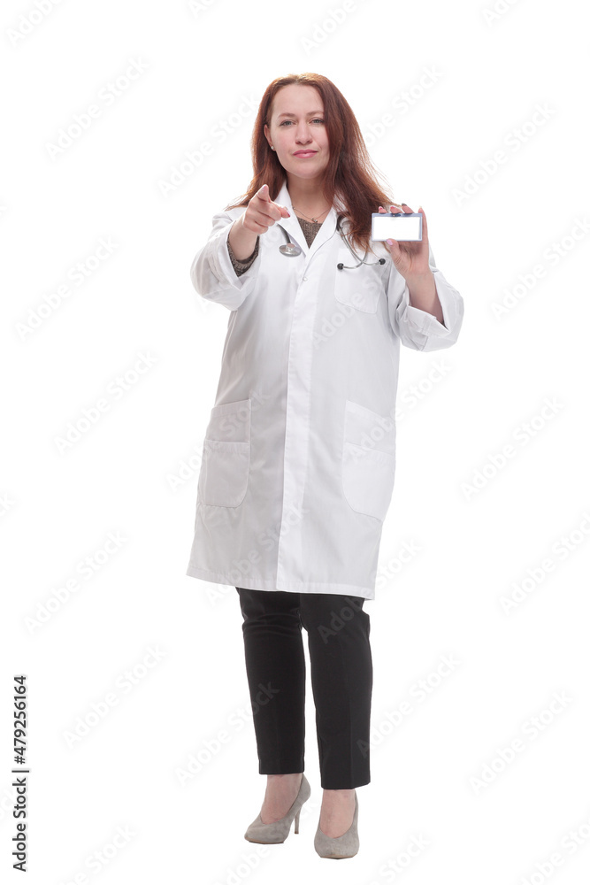 in full growth.qualified female doctor showing her visiting card. in full growth.qualified female doctor showing her visiting card.