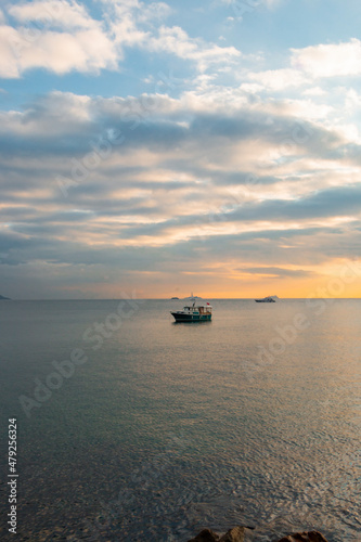 Boats in the Marmara sea. Sunset in Istanbul. Ancient oriental town in pastel colors. Cloudy weather. Text space. © burhan