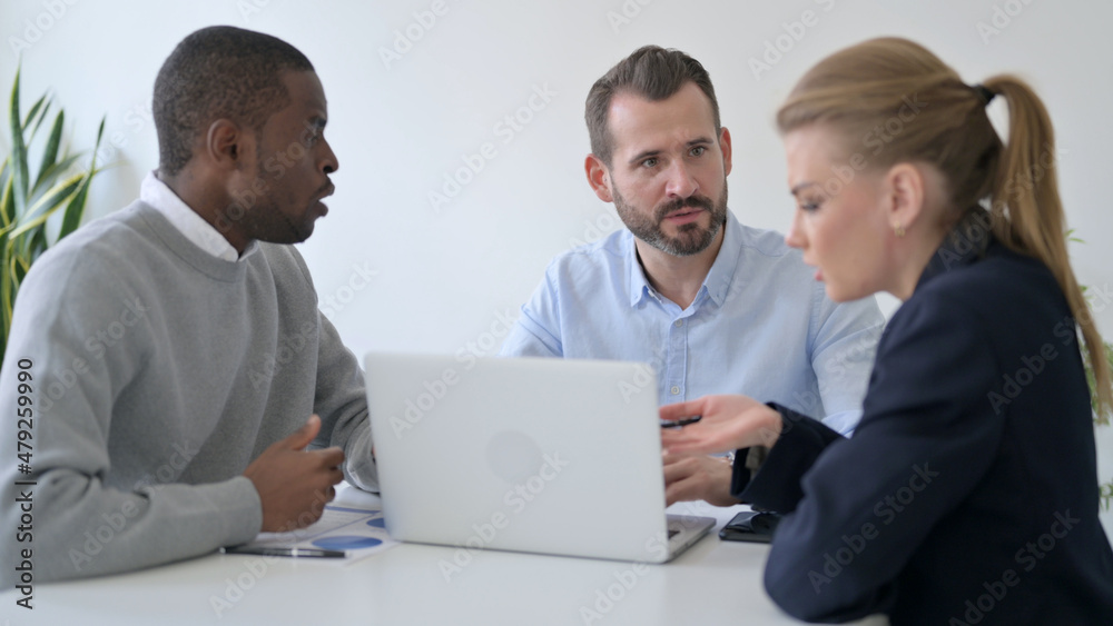Business People Arguing while using Laptop in Office Business People Arguing while using Laptop in Office
