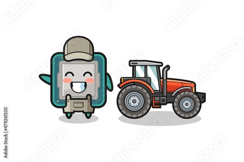 the processor farmer mascot standing beside a tractor