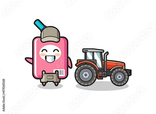 the milk box farmer mascot standing beside a tractor