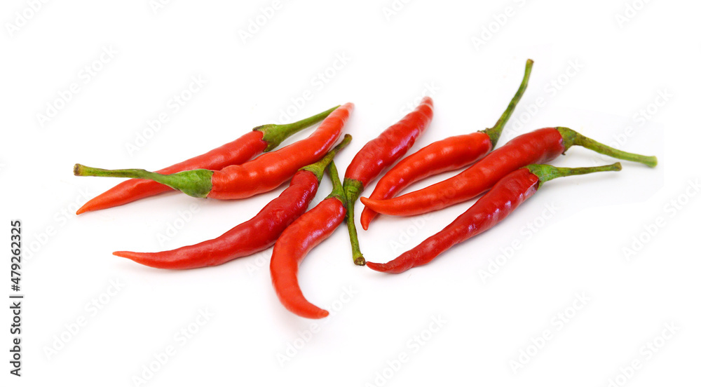 Stack red chili peppers and basil herb leaves  on the white