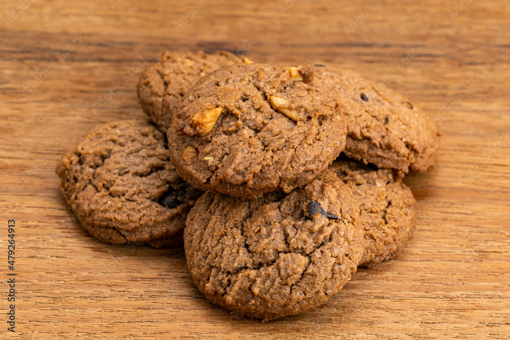 Pile of delicious chocolate chip butter cookies on wooden table. Group of dessert snack, cookies, pile on wooden table. Pile of delicious chocolate chip butter cookies on wooden table. Group of dessert snack, cookies, pile on wooden table.