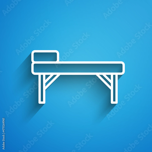 White line Massage table icon isolated on blue background. Long shadow. Vector
