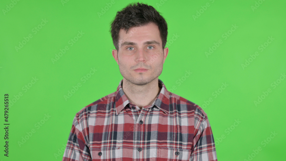 Portrait of Serious Young Man Looking at the Camera, Green Chroma Screen Portrait of Serious Young Man Looking at the Camera, Green Chroma Screen