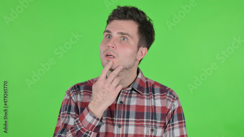 Portrait of Pensive Young Man Thinking New Plan, Green Chroma Screen