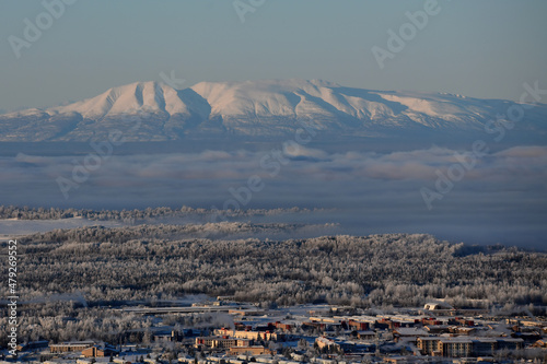 Mount Susitna, also known as Sleeping Lady,  rises 4,396 feet above a frosty Alaska winter landscape with Joint Base Elmendorf-Richardson in the foreground. photo