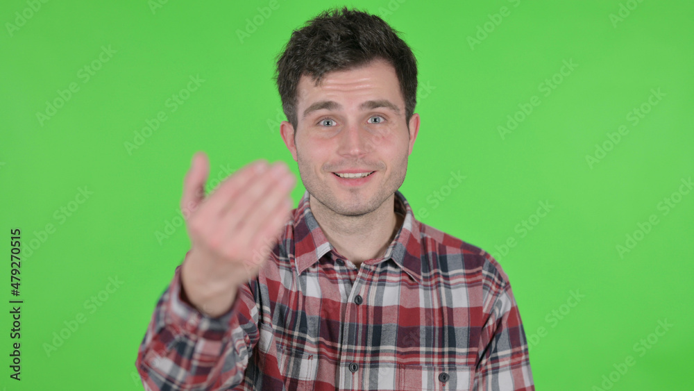 Portrait of Young Man Pointing at Camera, Inviting, Green Chroma Screen Portrait of Young Man Pointing at Camera, Inviting, Green Chroma Screen
