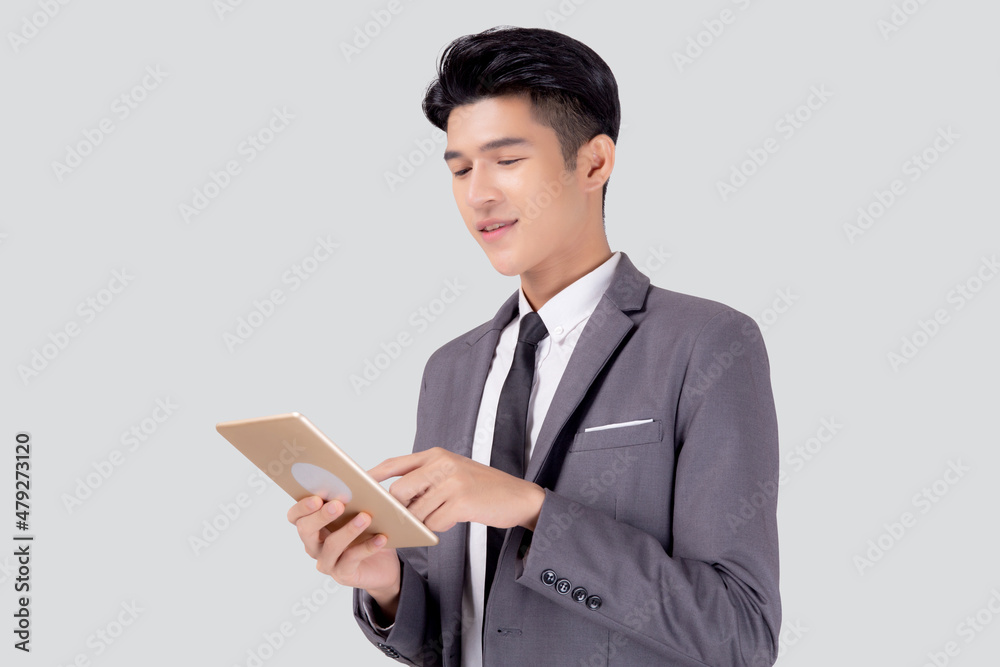 Portrait young asian business man in suit standing using tablet computer to internet isolated on white background, businessman confident touch screen digital pad with success, communication concept. Portrait young asian business man in suit standing using tablet computer to internet isolated on white background, businessman confident touch screen digital pad with success, communication concept.