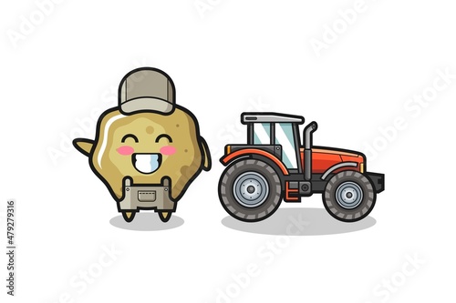 the loose stools farmer mascot standing beside a tractor