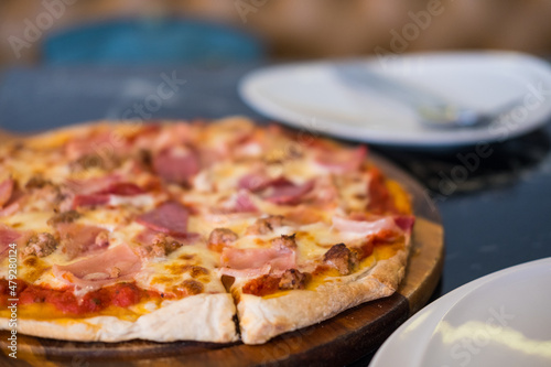 Pizza with bacon and salami.