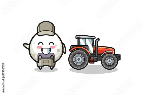 the onigiri farmer mascot standing beside a tractor
