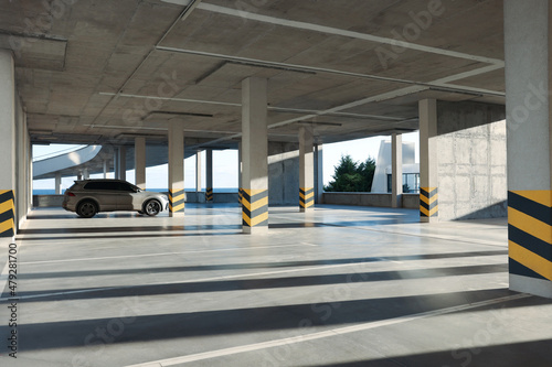 Open parking garage with car on sunny day