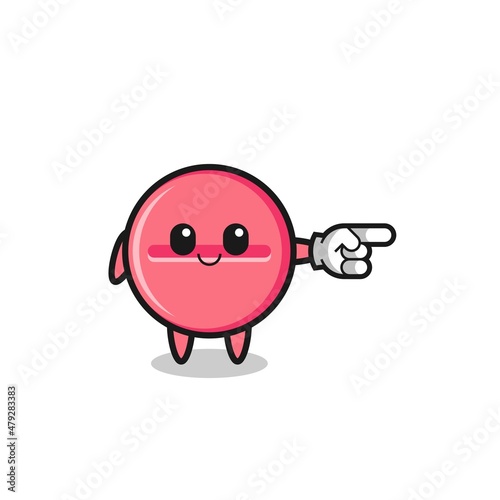 medicine tablet mascot with pointing right gesture