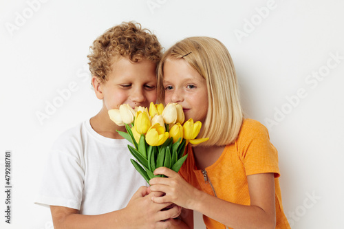 cheerful children fun birthday gift surprise bouquet of flowers isolated background unaltered