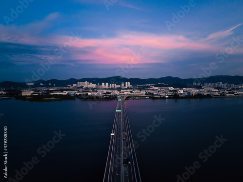 View of the bridge at sunrise which stands on the sea and connects the island and the mainland. It is the longest bridge in Malaysia