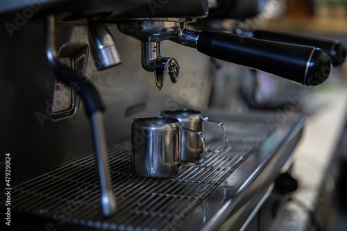 Close up of the process of making espresso in a professional coffee machine.