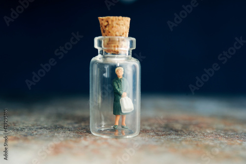 miniature figurine of a woman inside a mini glass bottle