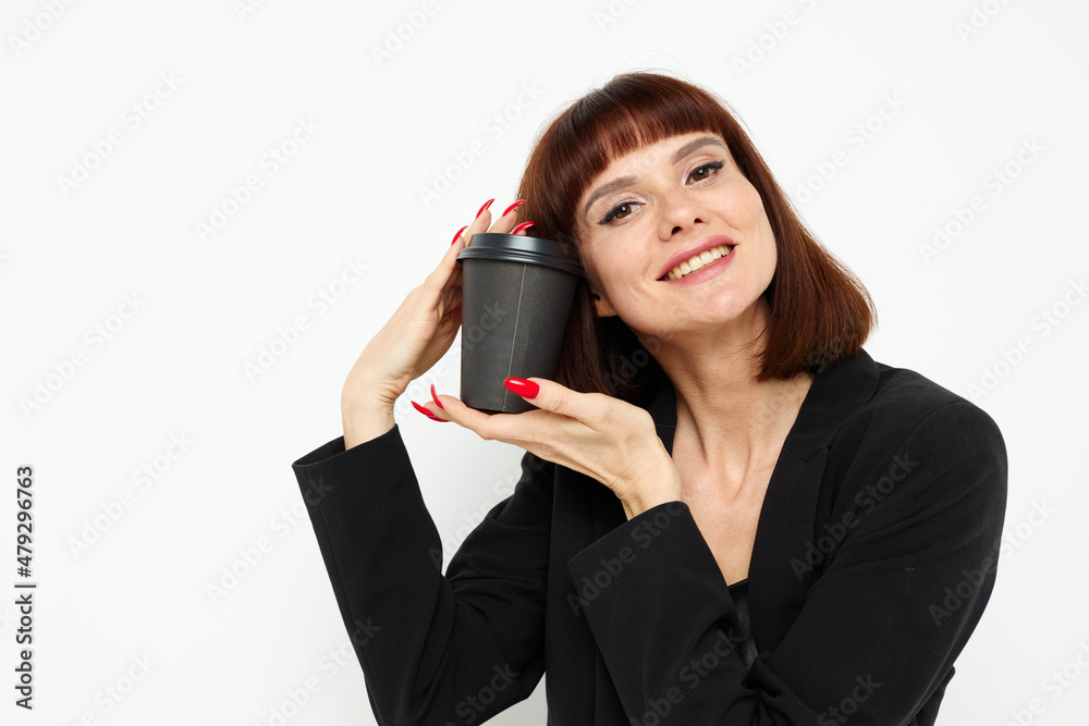 portrait of a woman in a black suit a mug with a drink charm Lifestyle unaltered portrait of a woman in a black suit a mug with a drink charm Lifestyle unaltered