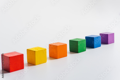 Six colored wooden blocks horizontal on white background. Index or infographic 6 with copy space. Toy Blocks, Wooden Cube Bricks
