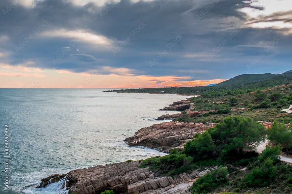 View of the coastline at sunset in Sierra de Irta natural park in Peniscola, Spanish Mediterranean